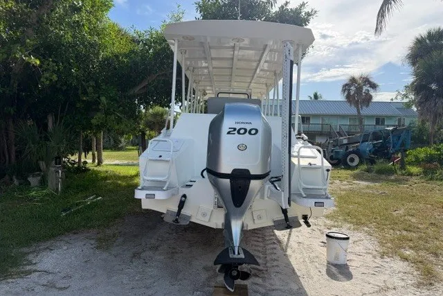 Slide: The Image of 2022 Gospel Boat Florida Landing Craft 9m with Honda 200 engine, parked outdoors. - 9