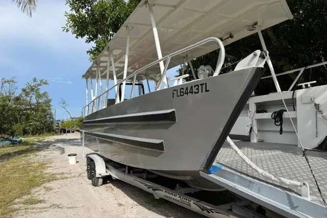 Slide: The Image of Gospel Boat Florida Landing Craft 9m, 2022 model, on trailer in outdoor setting. - 4