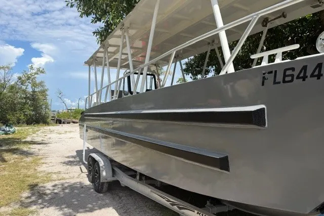 Slide: The Image of 2022 Gospel Boat Florida Landing Craft 9m on trailer, parked outdoors under trees. - 5