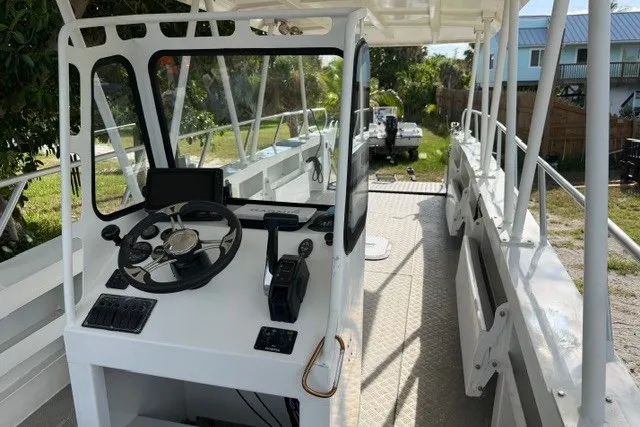 Slide: The Image of Cockpit view of 2022 Gospel Boat Florida Landing Craft 9m, showcasing steering and controls. - 6