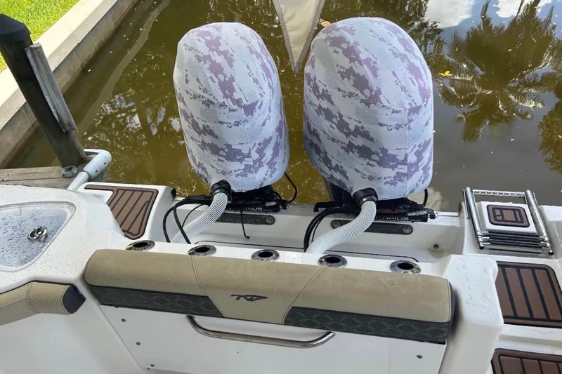 Slide: The Image of 2021 Tidewater 272 CC Adventure boat with dual camo-covered outboard motors. - 4