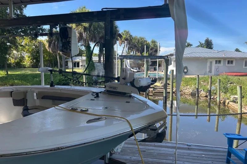 Slide: The Image of 2021 Tidewater 272 CC Adventure boat docked near waterfront home. - 3
