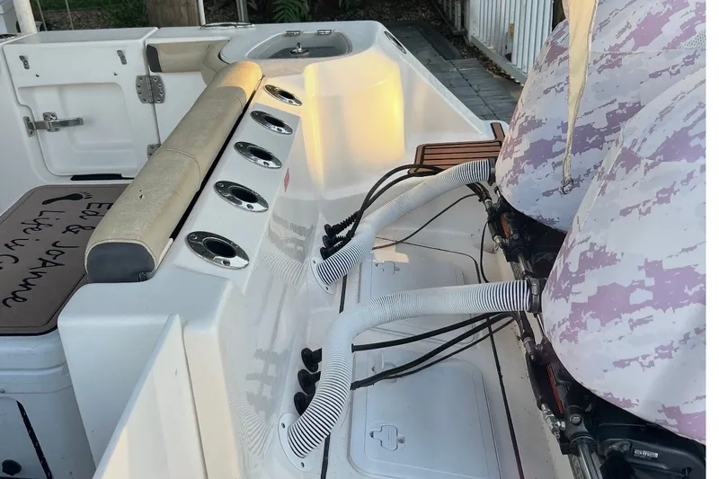 Slide: The Image of 2021 Tidewater 272 CC Adventure boat interior with seating and engine details. - 12