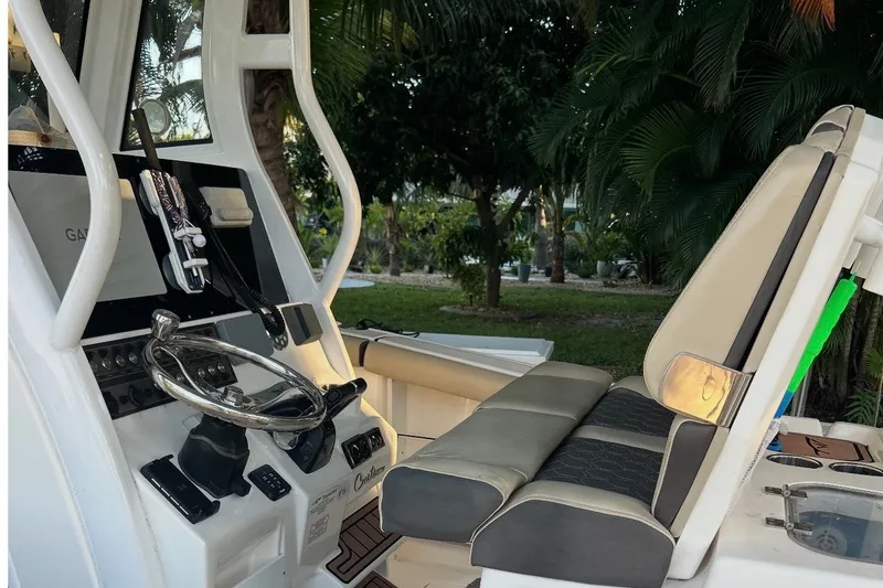 Slide: The Image of 2021 Tidewater 272 CC Adventure boat cockpit with steering wheel and seating. - 5