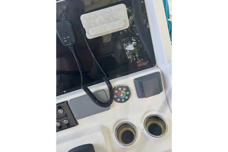 Slide: The Image of Control panel of 2021 Tidewater 272 CC Adventure boat with radio and cup holders. - 18