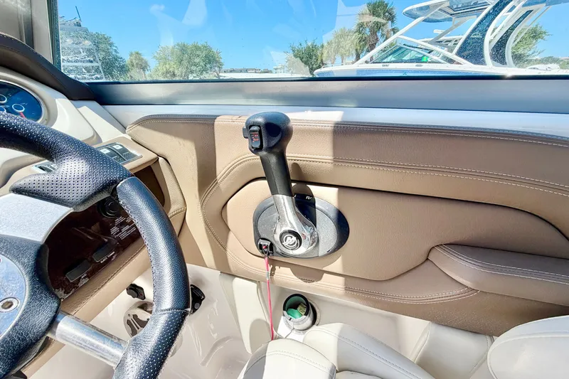 Slide: The Image of Interior view of 2015 Chaparral 224 Sunesta boat cockpit with steering wheel and throttle controls. - 19