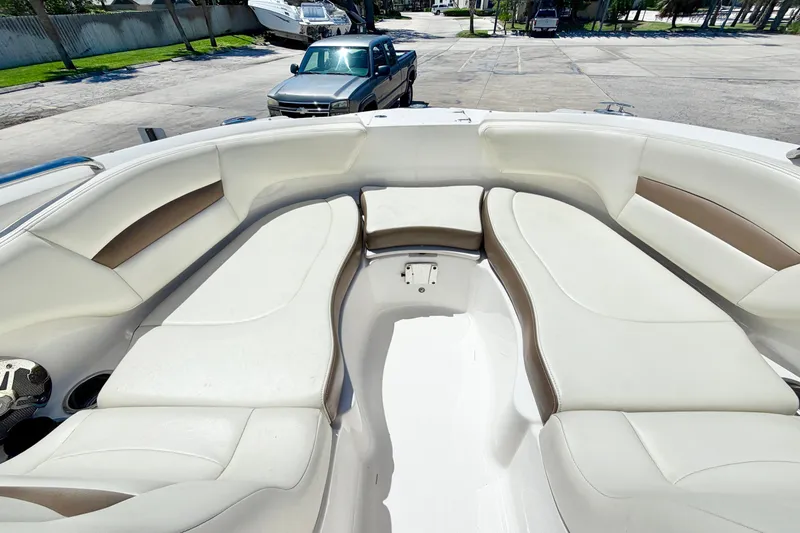 Slide: The Image of 2015 Chaparral 224 Sunesta boat interior with white and tan seating. - 22