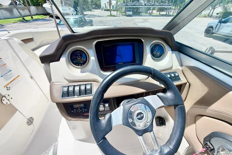 Slide: The Image of 2015 Chaparral 224 Sunesta boat dashboard with steering wheel and gauges. - 18