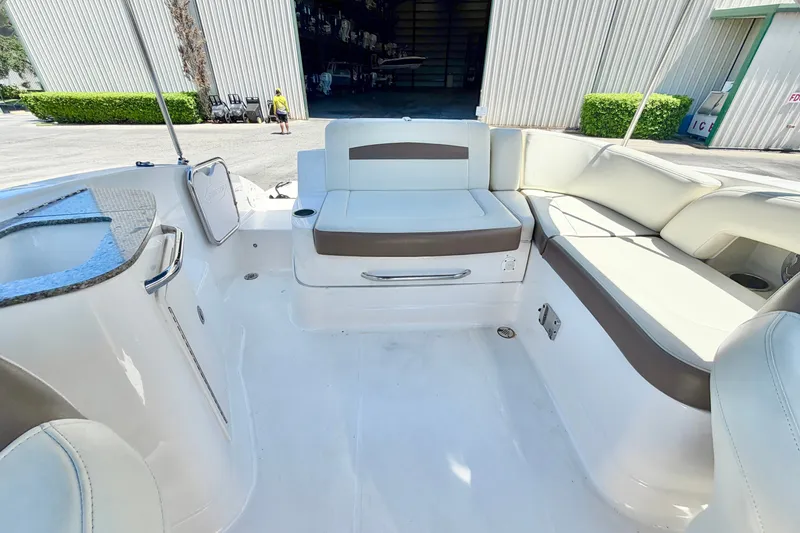 Slide: The Image of 2015 Chaparral 224 Sunesta boat interior with spacious seating and sleek design. - 11