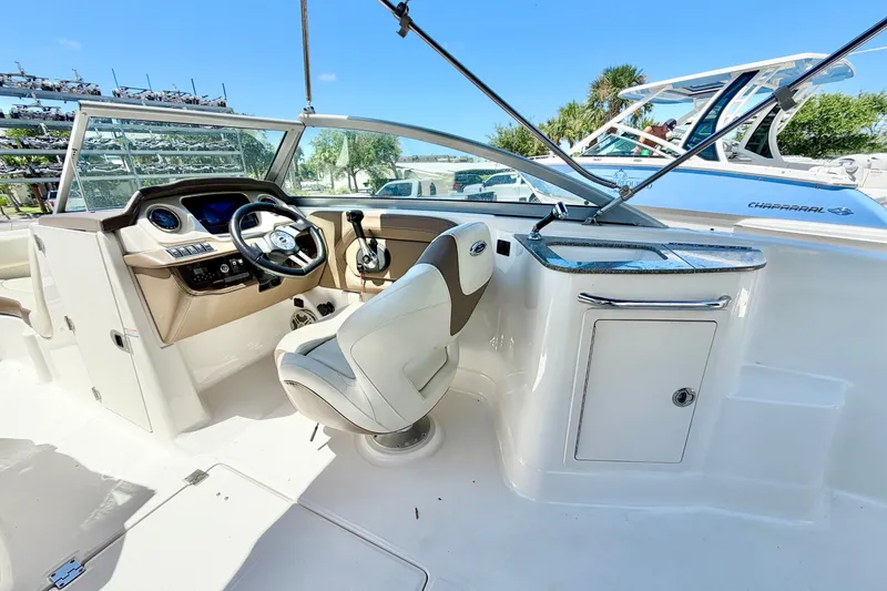 Slide: The Image of 2015 Chaparral 224 Sunesta boat interior with steering wheel and dashboard. - 14
