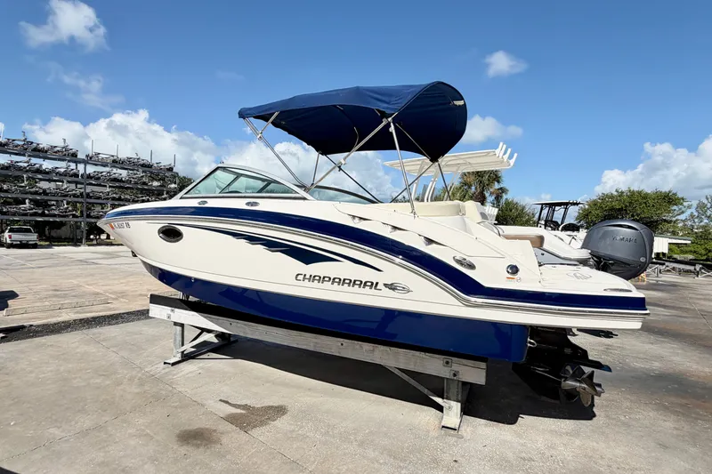 Slide: The Image of 2015 Chaparral 224 Sunesta boat with blue canopy on a sunny day. - 3