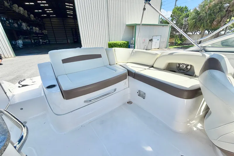 Slide: The Image of 2015 Chaparral 224 Sunesta boat interior with white and brown seating. - 12
