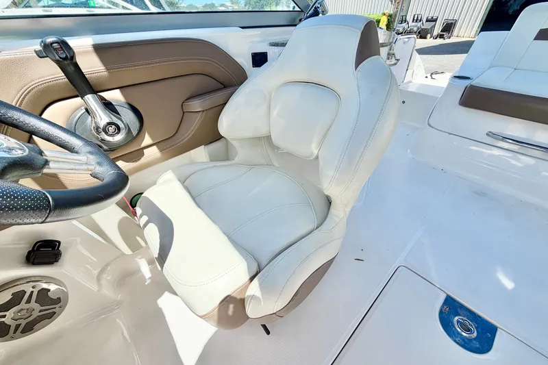 Slide: The Image of Interior of 2015 Chaparral 224 Sunesta boat featuring steering wheel and plush seating. - 17