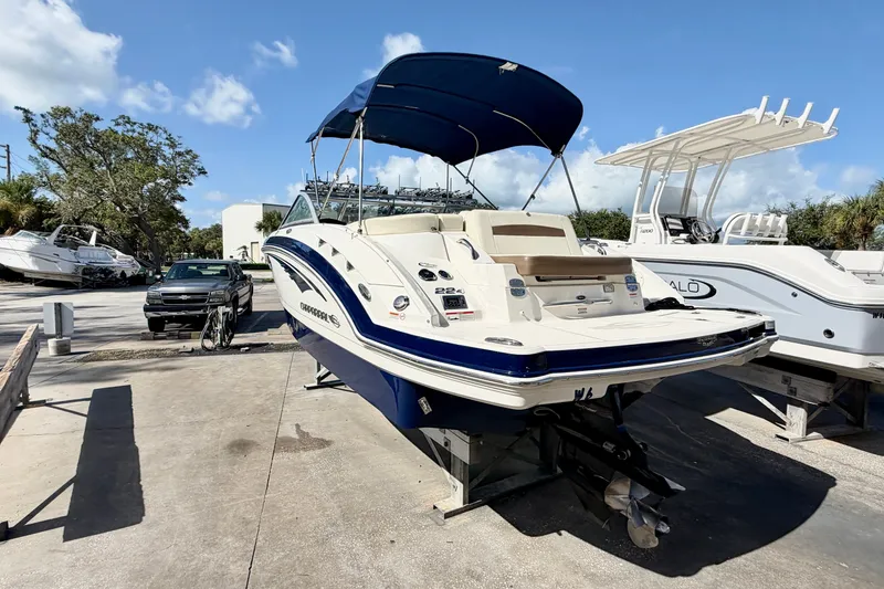 Slide: The Image of 2015 Chaparral 224 Sunesta boat with blue canopy on display outdoors. - 4