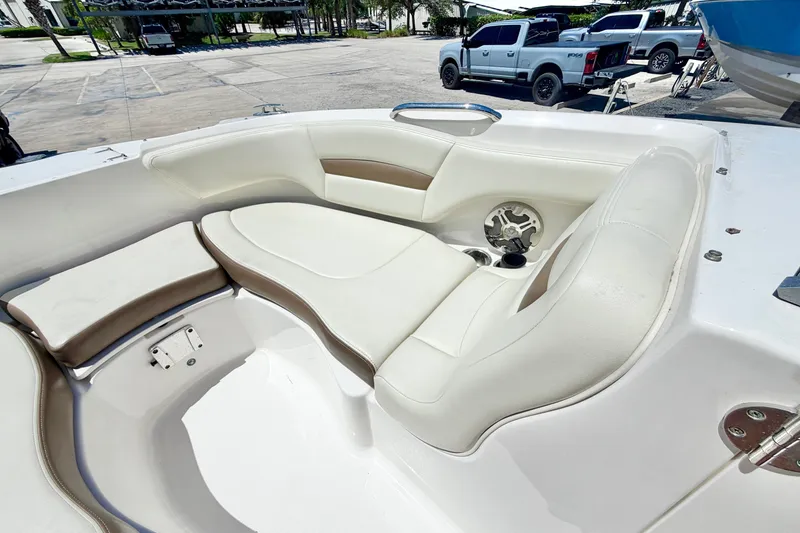 Slide: The Image of 2015 Chaparral 224 Sunesta boat interior with white and beige seating. - 23