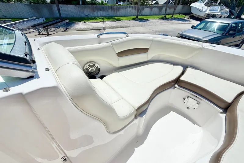 Slide: The Image of 2015 Chaparral 224 Sunesta boat interior with white and beige seating. - 21