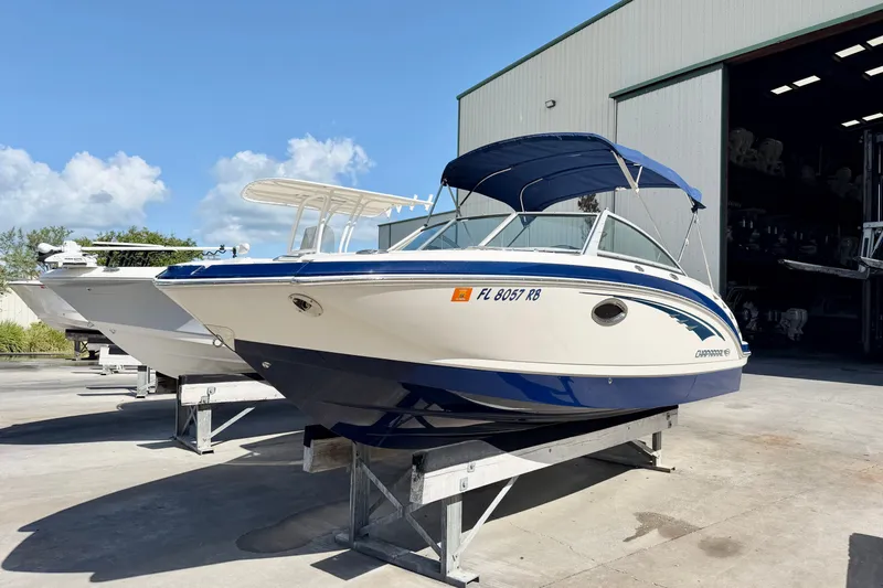 Slide: The Image of 2015 Chaparral 224 Sunesta boat with blue canopy on display outside a storage facility. - 1