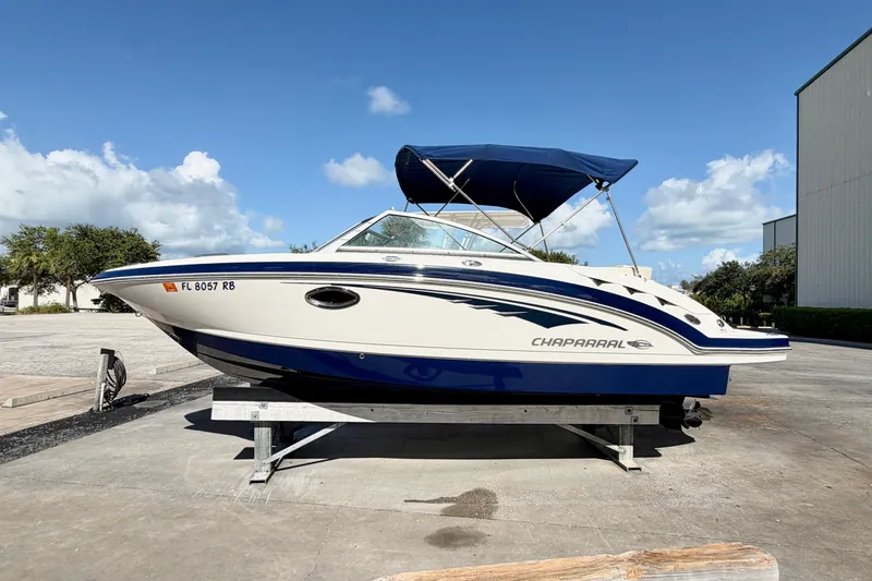 Slide: The Image of 2015 Chaparral 224 Sunesta boat with blue canopy on a sunny day. - 2