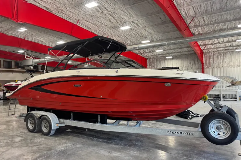 The Image of Red 2015 Sea Ray SDX 270 boat on trailer in indoor showroom. - 1