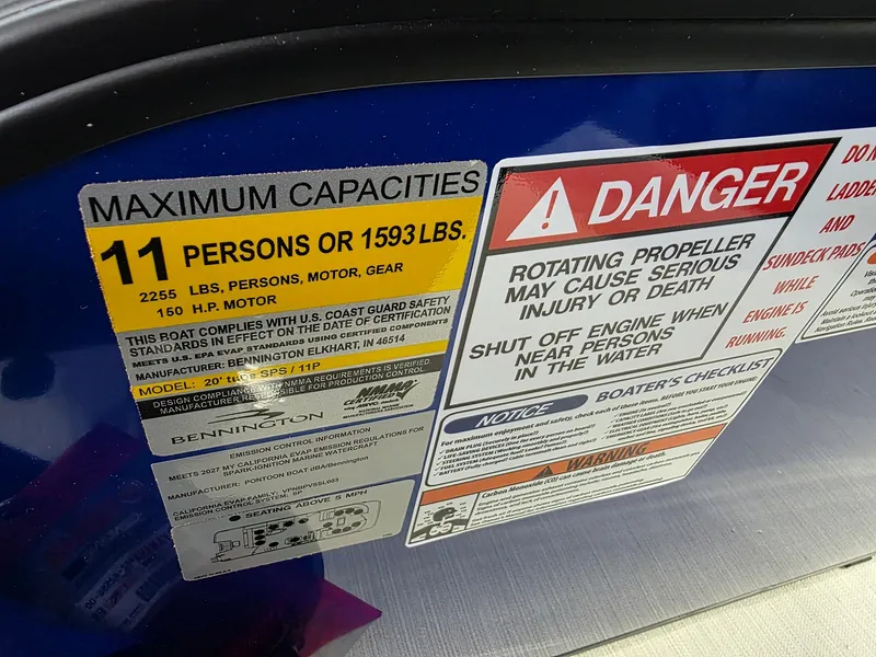 Slide: The Image of Safety and capacity labels on a 2027 Bennington 21ML SPS TRI boat. - 17