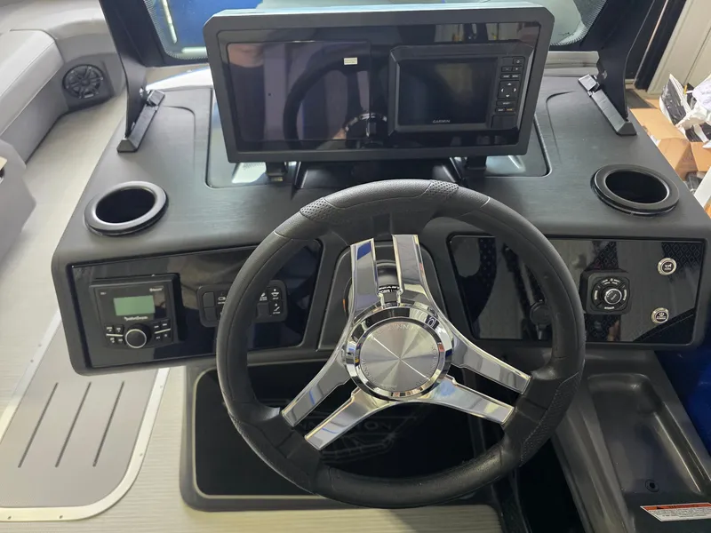 Slide: The Image of The image shows the helm of a 2027 Bennington 21ML SPS TRI boat with modern instruments. - 16