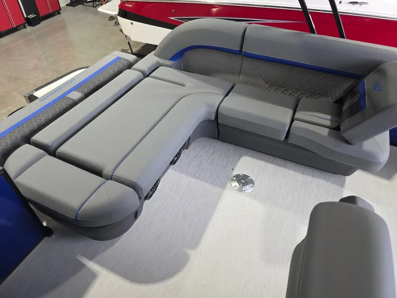 Slide: The Image of The image shows the gray and blue upholstery of a 2027 Bennington 21ML SPS TRI. - 15