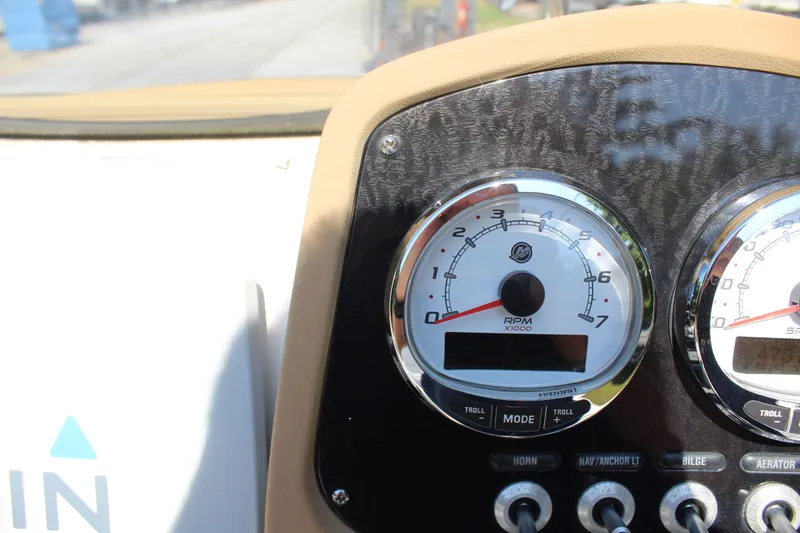 Slide: The Image of Close-up of a boat dashboard with tachometer and controls. - 15