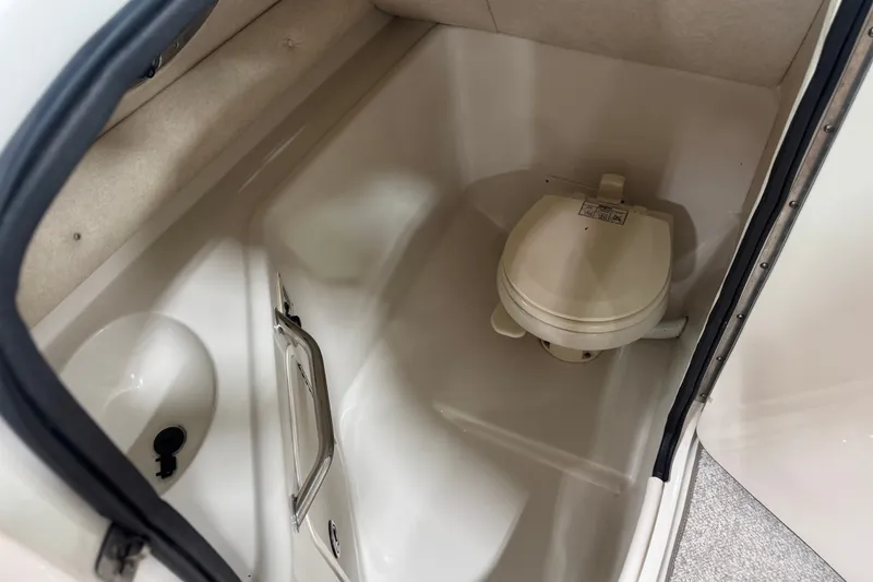 Slide: The Image of Interior view of a 2008 Sea Ray 240 Sundeck boat bathroom with toilet. - 12