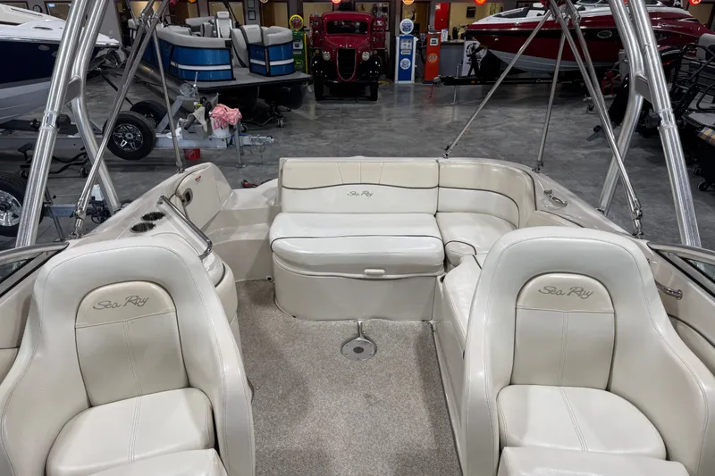 Slide: The Image of Interior of a 2008 Sea Ray 240 Sundeck boat with white seating and spacious layout. - 7