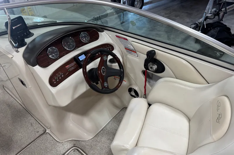 Slide: The Image of Interior view of 2008 Sea Ray 240 Sundeck boat cockpit with steering wheel and gauges. - 9