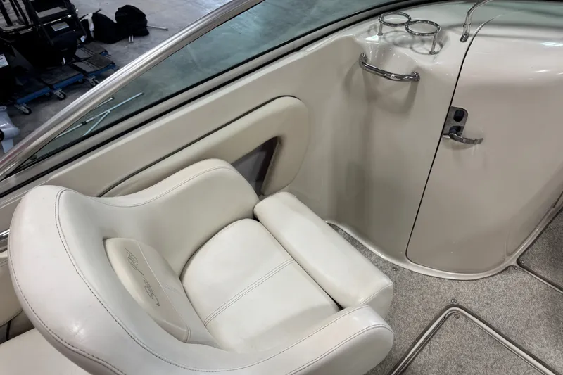 Slide: The Image of 2008 Sea Ray 240 Sundeck interior with white seating and cup holders. - 11