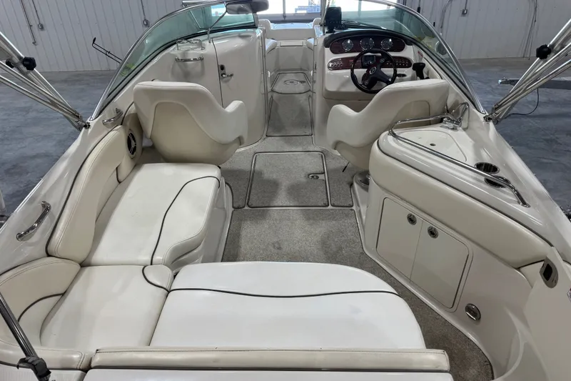 Slide: The Image of Interior of a 2008 Sea Ray 240 Sundeck boat with white seating and dashboard. - 6