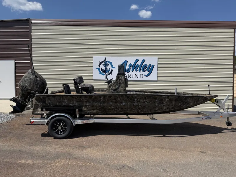 The Image of An Excel Boats Bay Pro 203 203 ELITE-SEADECK on a trailer in front of a building. - 1