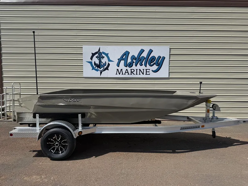 The Image of An Edge Duck Boat Sportsman Series 553 from 2027 sits on a trailer in front of a building with an "Ashley Marine" sign. - 1