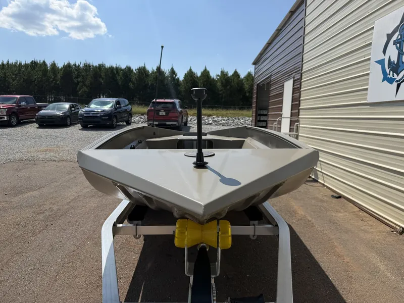 Slide: The Image of An Edge Duck Boat Sportsman Series 553 from 2027 on a trailer beside a building. - 5