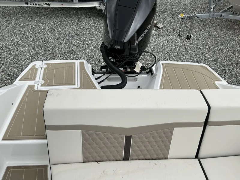 Slide: The Image of The image shows the stern of a Monterey M-205 boat with an outboard motor and cushioned seats. - 12