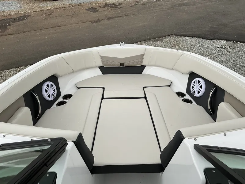 Slide: The Image of The image shows the bow area of a Monterey M-205 boat with beige upholstery and speakers. - 7