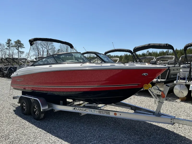 Slide: The Image of A red 2025 Monterey 224FS boat is on a trailer in a gravel lot. - 3