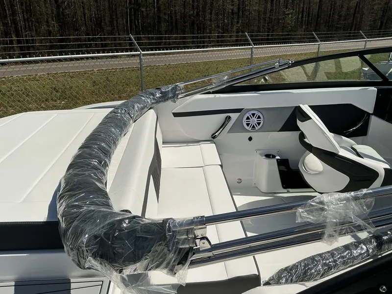 Slide: The Image of The image shows the cockpit of a 2025 Monterey M-22 boat with white seating and stainless steel railing. - 5