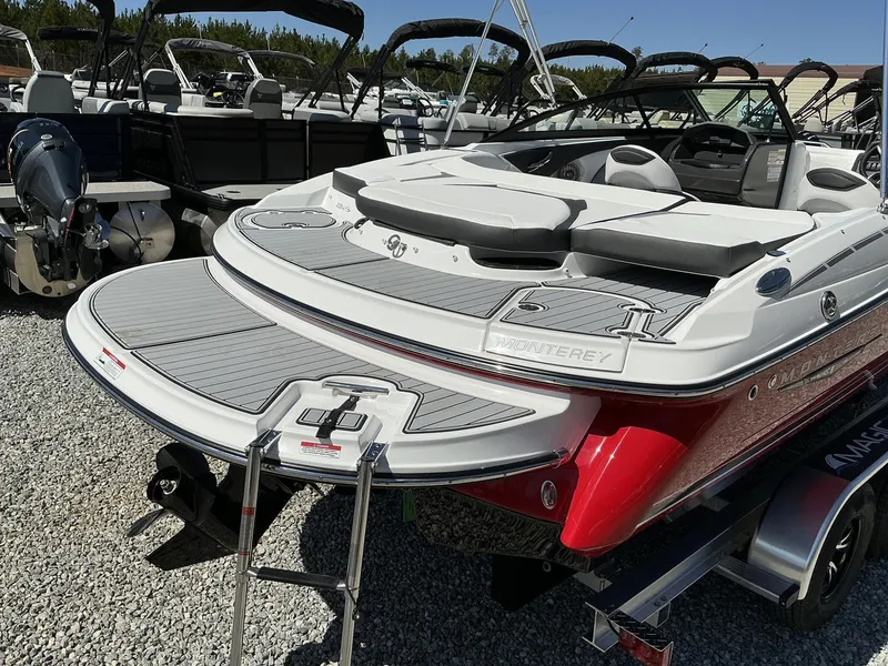 Slide: The Image of The image shows a red 2025 Monterey 224FS boat with a gray deck and swim platform. - 5