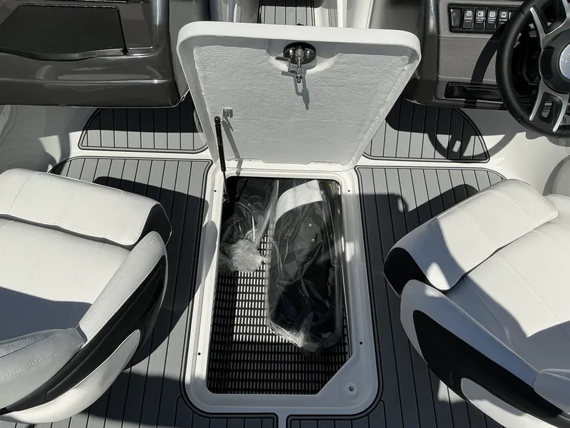 Slide: The Image of The image shows the interior of a 2025 Monterey 224FS boat with an open storage compartment. - 13