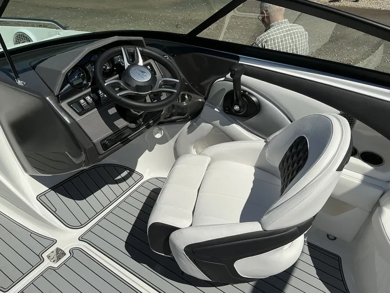Slide: The Image of The image shows the cockpit of a Monterey 224FS boat with a modern steering wheel and cushioned seat. - 18