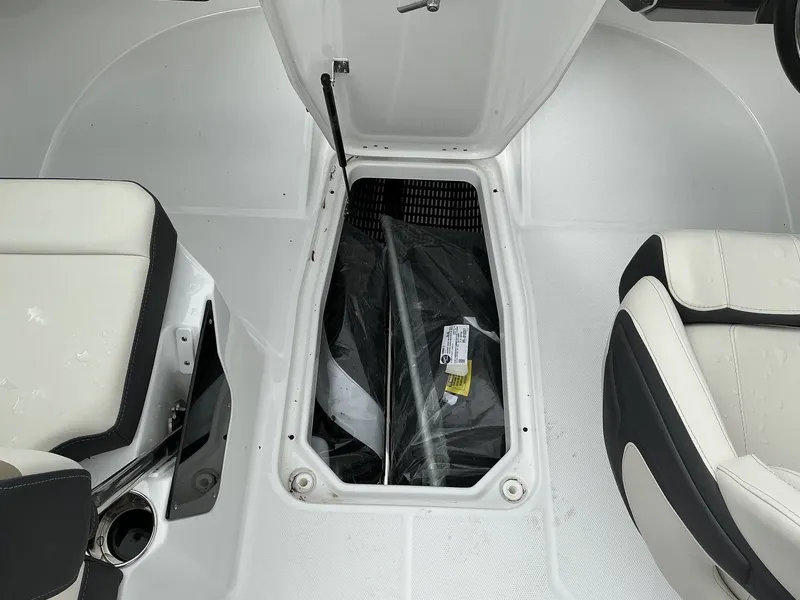 Slide: The Image of The image shows the interior of a 2025 Monterey M-205 boat with an open storage compartment. - 14