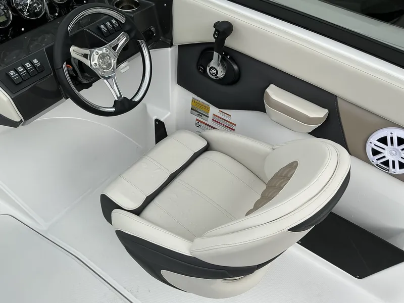 Slide: The Image of The image shows the helm of a 2025 Monterey M-205 boat with a sleek white seat. - 8