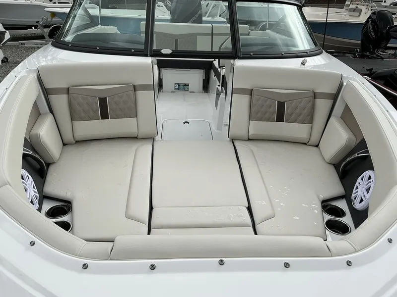 Slide: The Image of The image shows the bow area of a Monterey M-205 boat with beige upholstery and cup holders. - 3