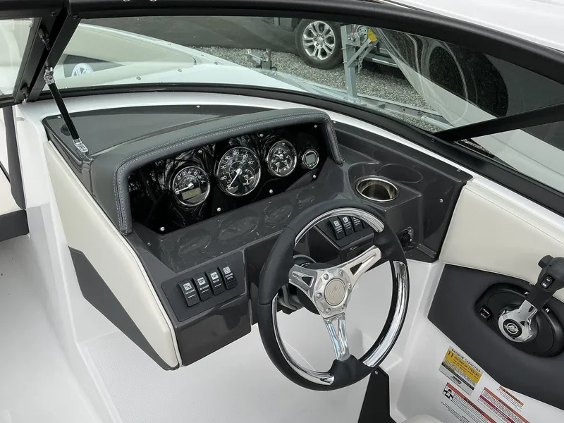Slide: The Image of The image shows the cockpit of a Monterey M-205 boat with a modern dashboard and steering wheel. - 9