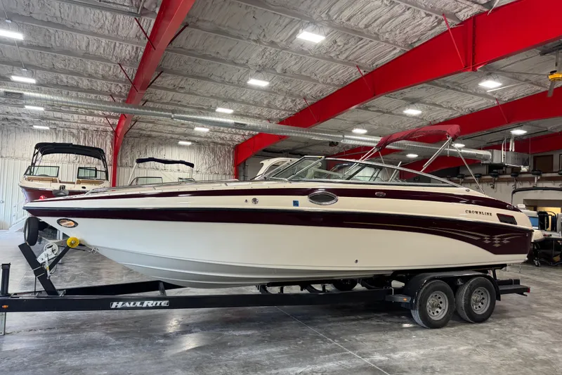 The Image of 2004 Crownline 270 BR boat on trailer in indoor storage facility. - 1