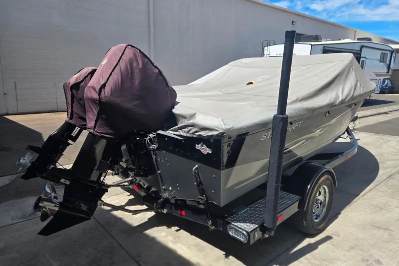 Slide: The Image of Covered 2005 Starcraft Futura 180 DC boat on trailer, parked outdoors. - 14