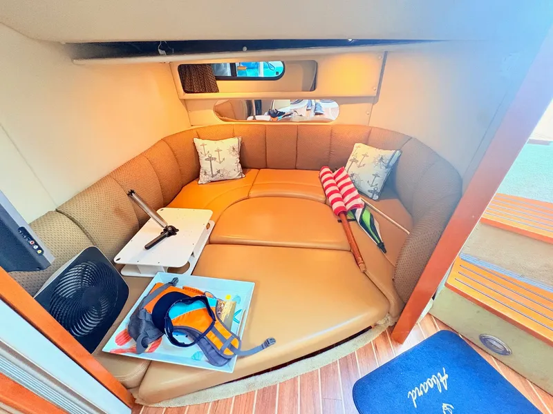 Slide: The Image of Interior of a 2007 Chaparral Signature 350 with a cozy seating area and nautical-themed pillows. - 20