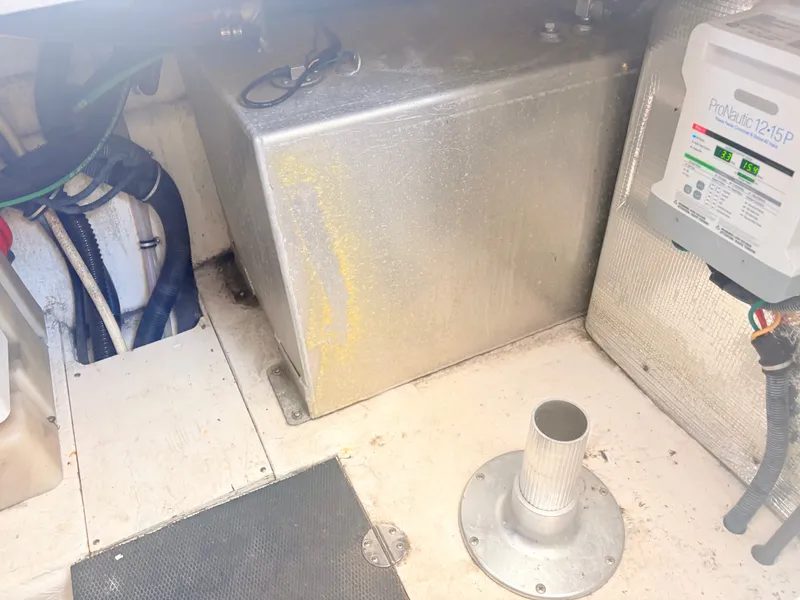 Slide: The Image of An engine room with a metal tank, hoses, and an electrical device on the wall. - 28